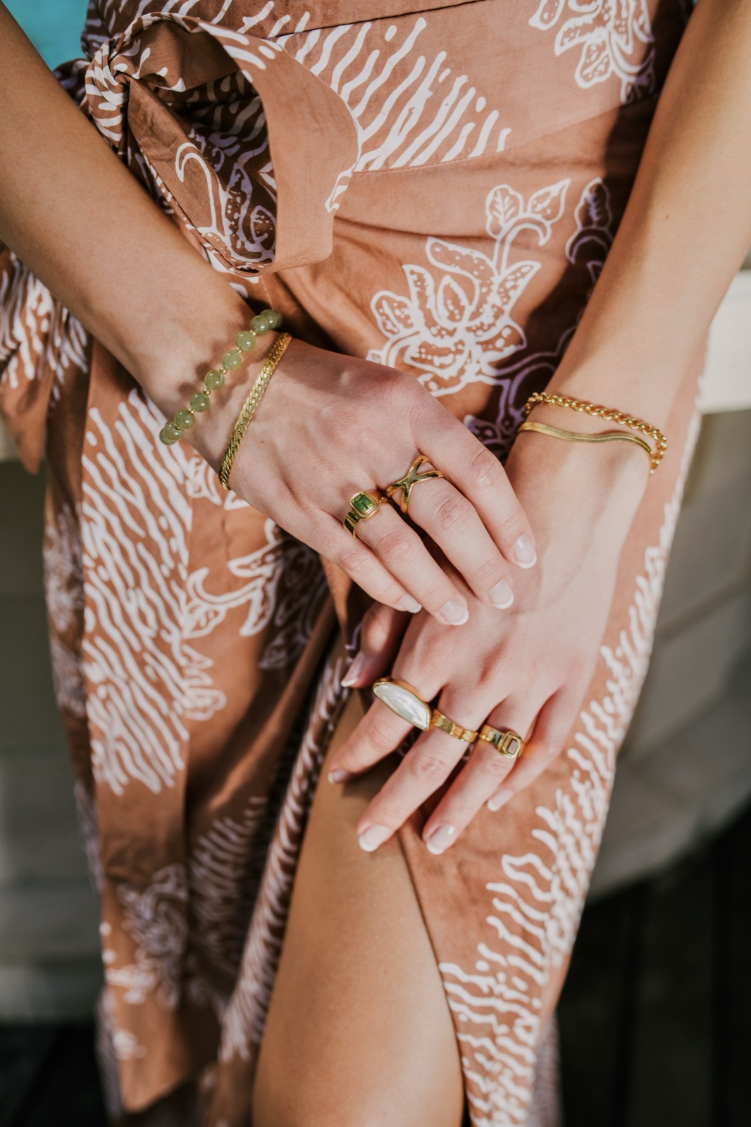 Gold jewelry detail shot over a batik sarong